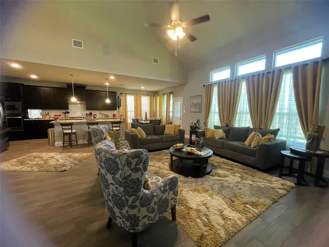 a living room with furniture and a large window