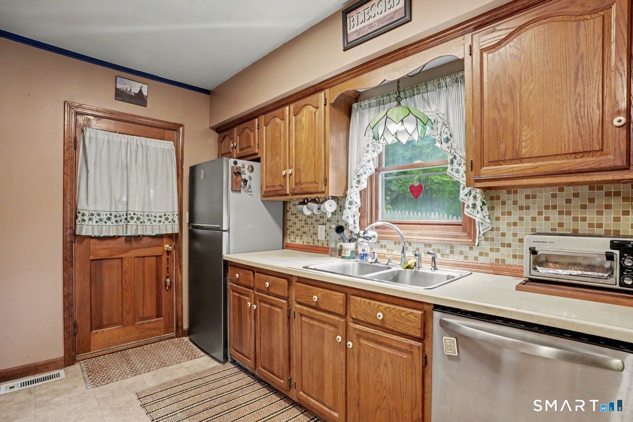 74 Maple Street Seymour, CT 06483 - Photo 7 of 40 a kitchen with stainless steel appliances granite countertop a sink stove and cabinets