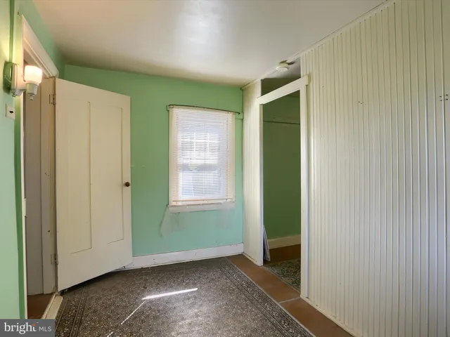 a view of a room with table and chairs