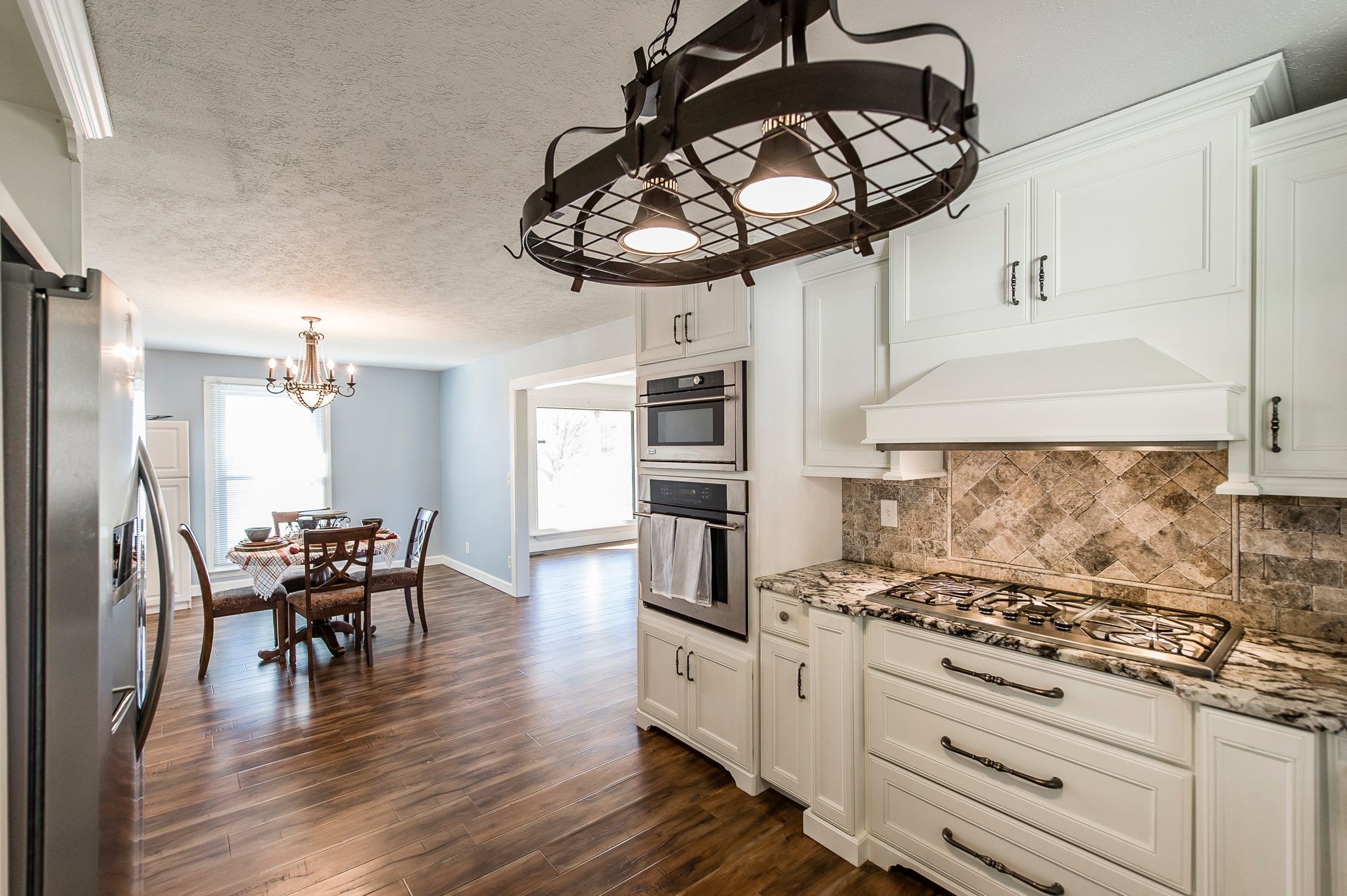 1881 Pinnacle Road Pleasant View, TN 37146 - Photo 19 of 62 a kitchen with stainless steel appliances granite countertop a stove and a wooden floors