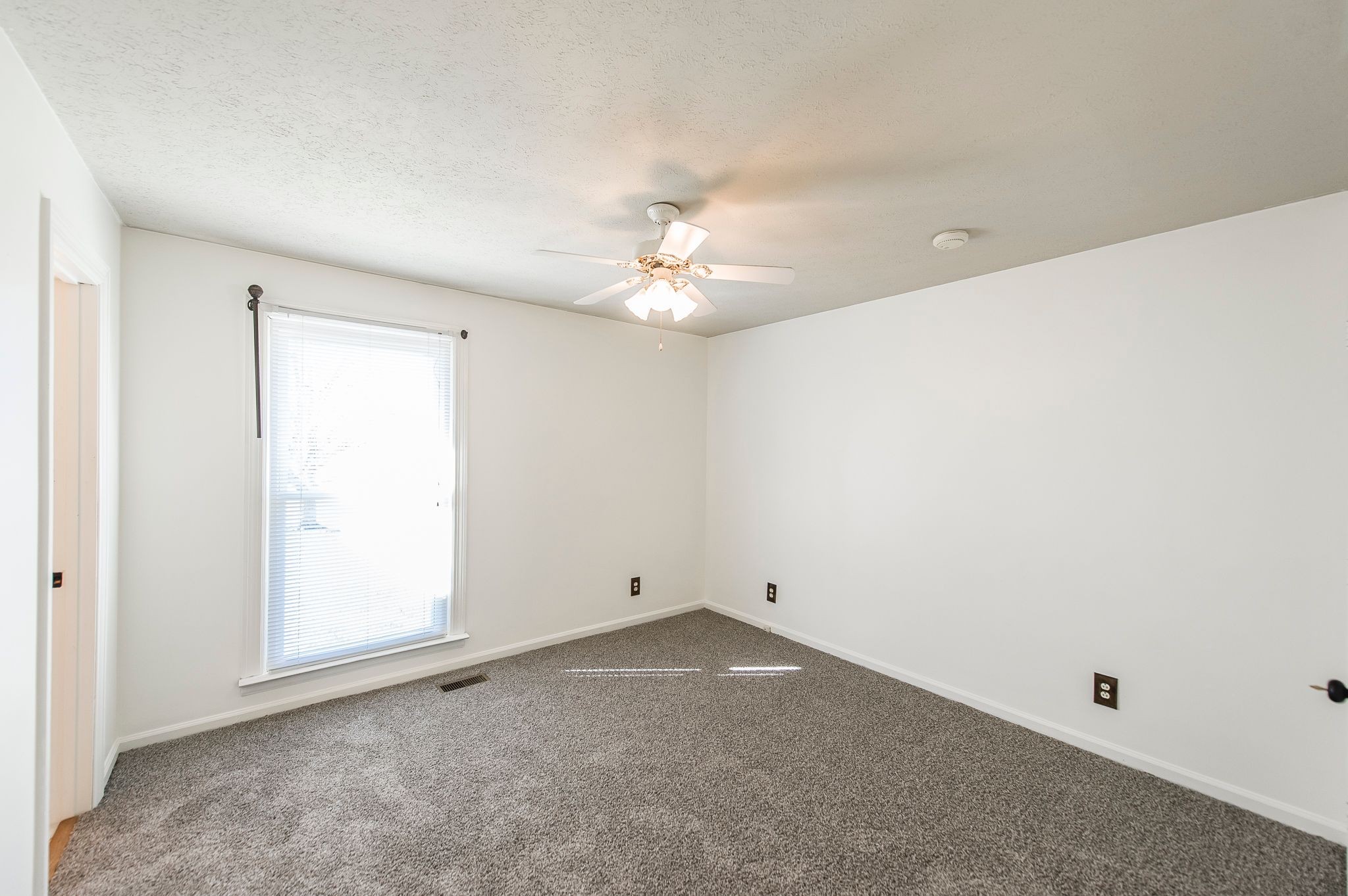 1881 Pinnacle Road Pleasant View, TN 37146 - Photo 22 of 62 an empty room with a ceiling fan and a window