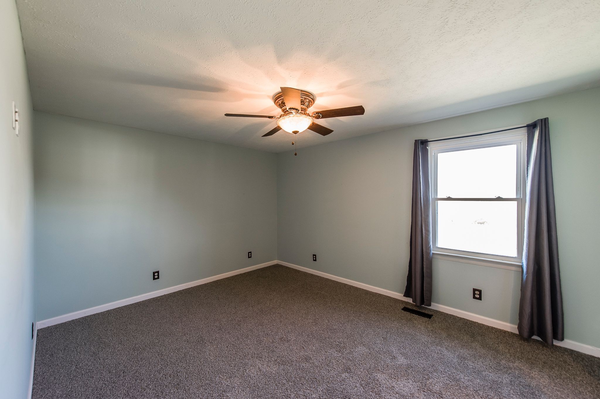 1881 Pinnacle Road Pleasant View, TN 37146 - Photo 26 of 62 an empty room with chandelier fan and windows