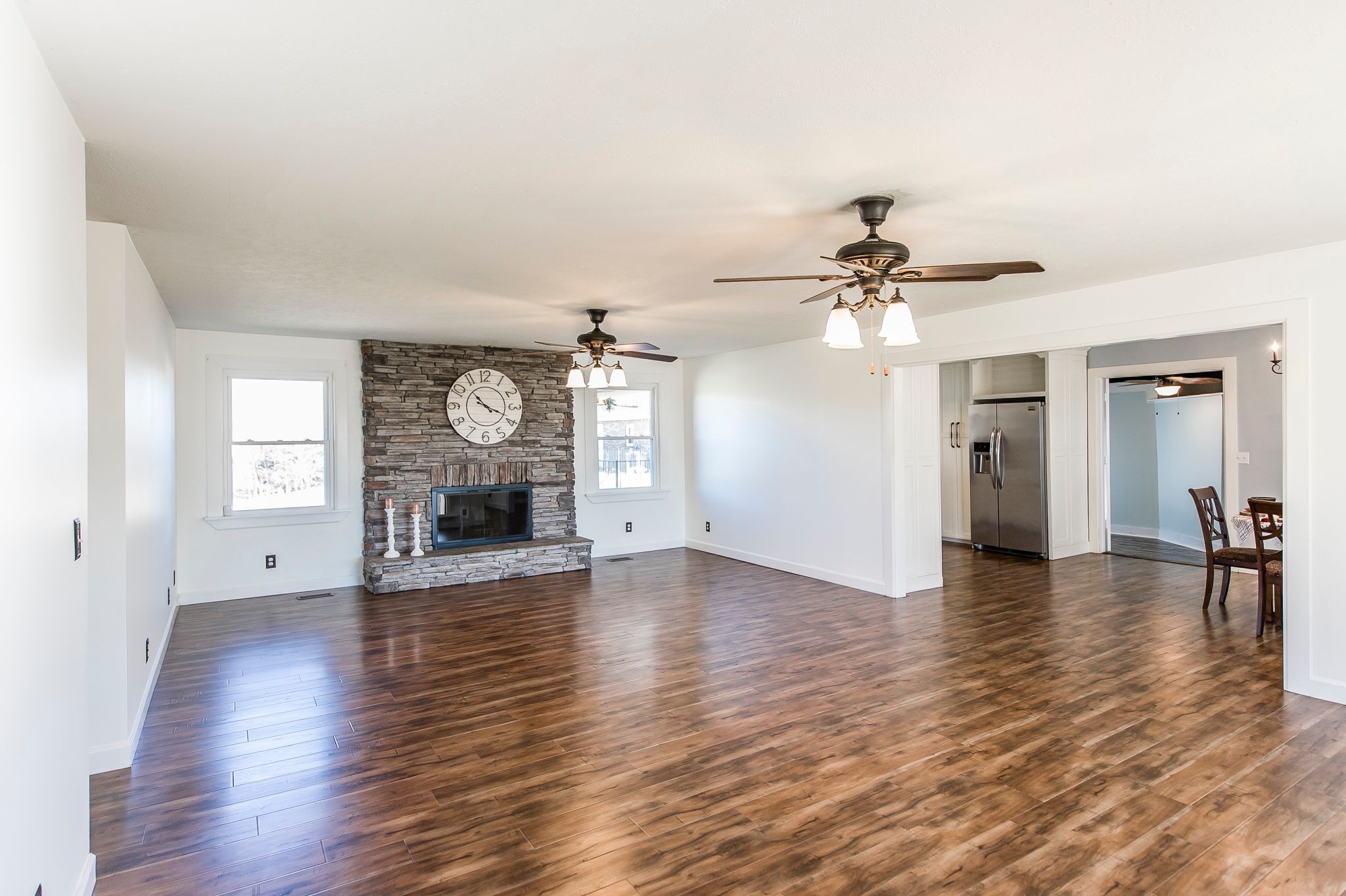 1881 Pinnacle Road Pleasant View, TN 37146 - Photo 8 of 62 an empty room with wooden floor a ceiling fan and windows