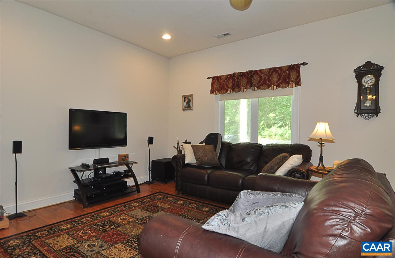 341 Grace Johnson Road Kents Store, VA 23084 - Photo 11 of 32 a living room with furniture and a flat screen tv
