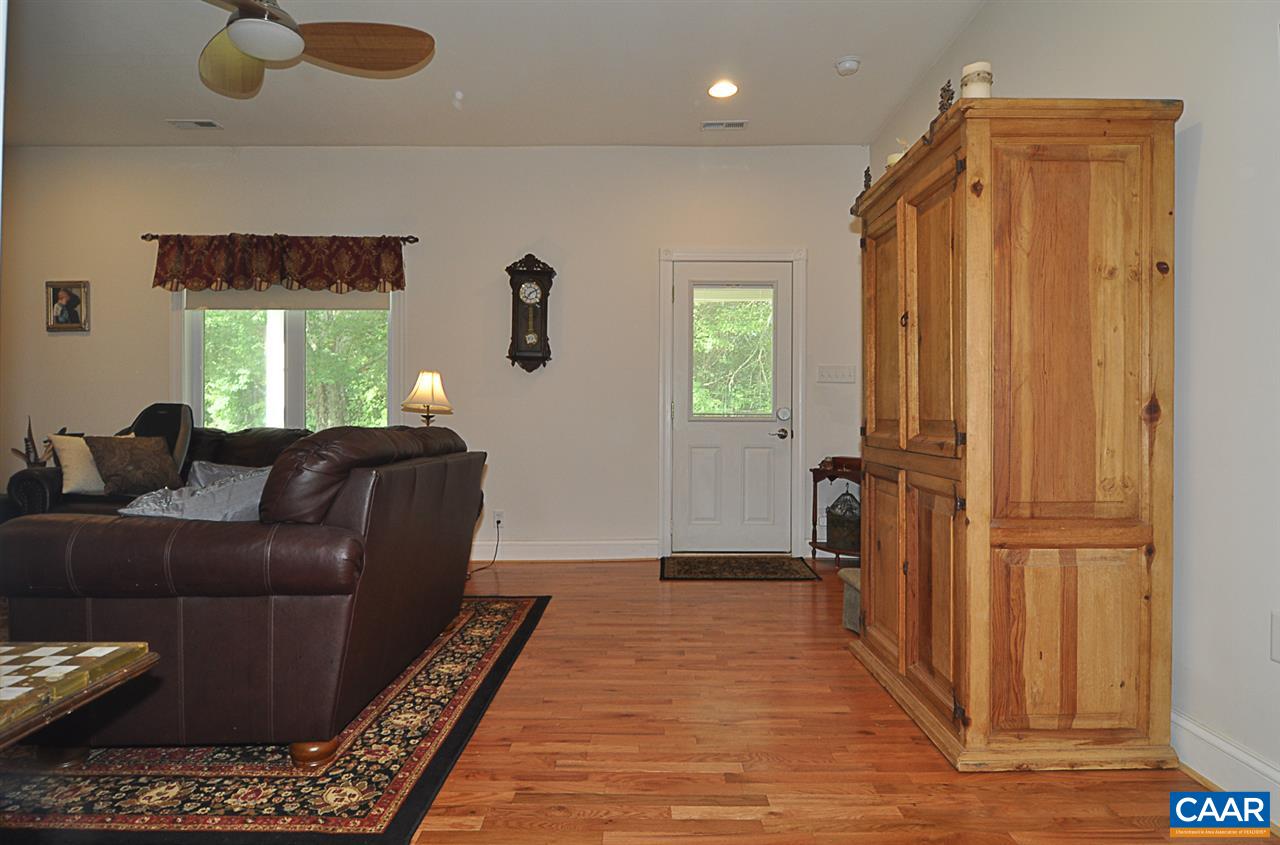 341 Grace Johnson Road Kents Store, VA 23084 - Photo 13 of 32 a living room with furniture and a gate