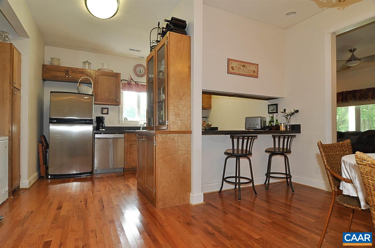 341 Grace Johnson Road Kents Store, VA 23084 - Photo 15 of 32 a kitchen with stainless steel appliances granite countertop a refrigerator microwave and wooden floor