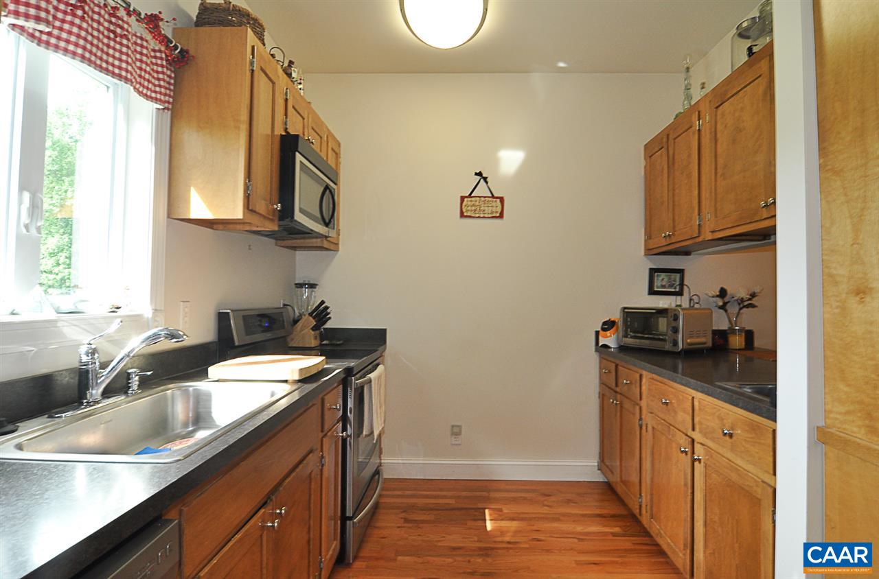 341 Grace Johnson Road Kents Store, VA 23084 - Photo 17 of 32 a kitchen with a sink dishwasher a stove and a refrigerator with wooden floor