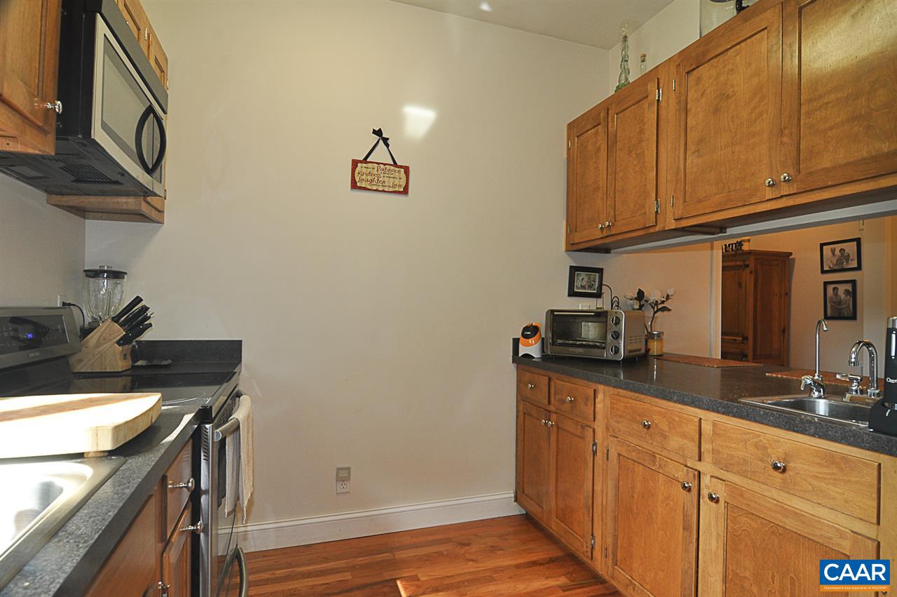 341 Grace Johnson Road Kents Store, VA 23084 - Photo 19 of 32 a kitchen with stainless steel appliances granite countertop a sink stove and cabinets