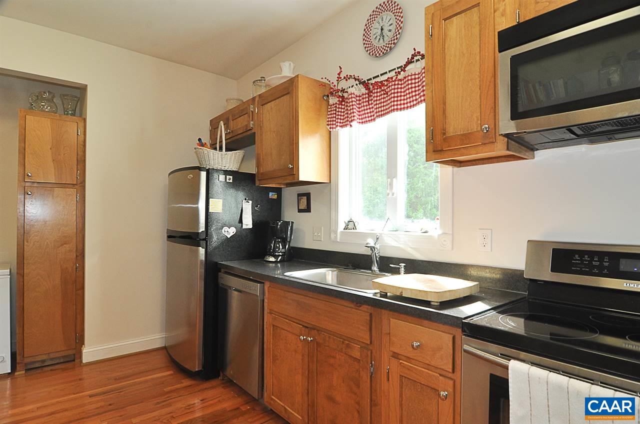 341 Grace Johnson Road Kents Store, VA 23084 - Photo 20 of 32 a kitchen with stainless steel appliances granite countertop a sink a microwave cabinets and a wooden floor