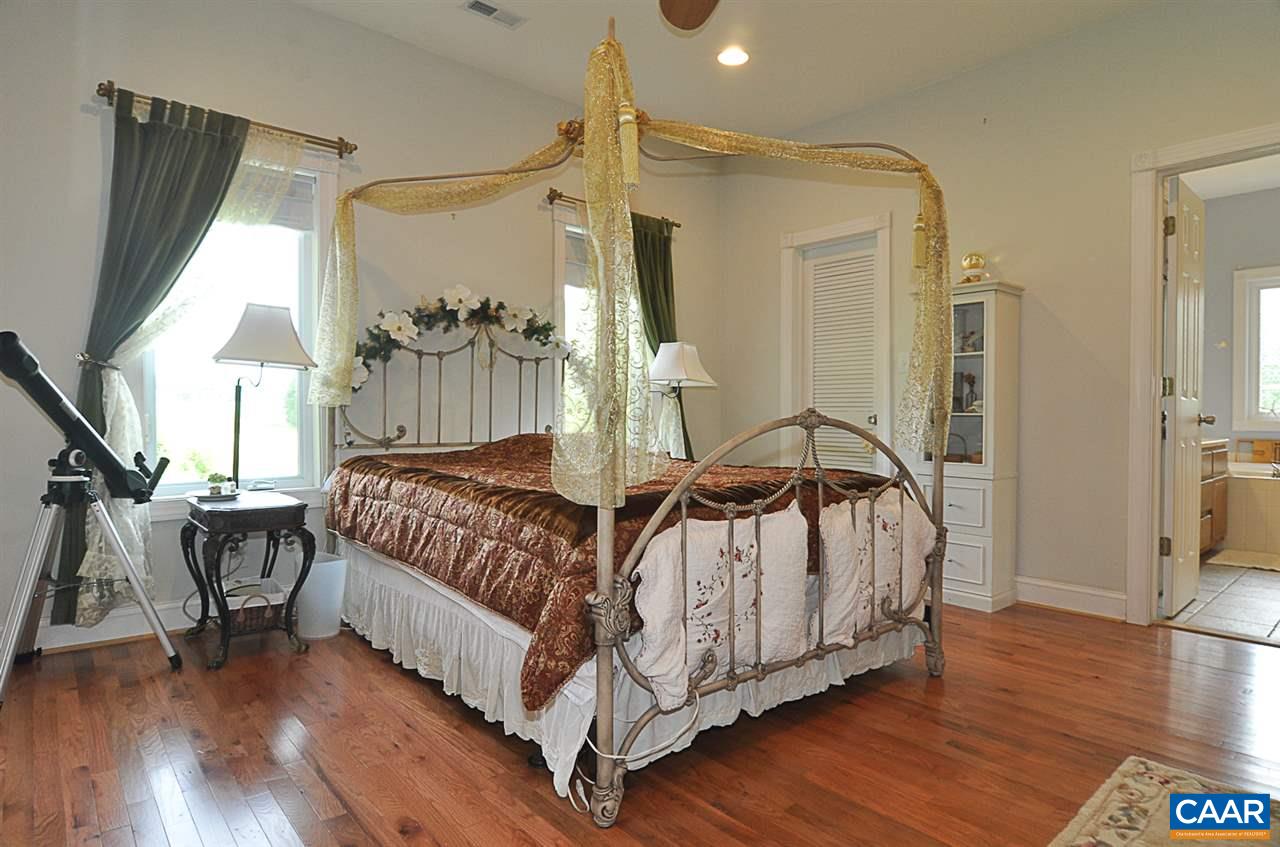 341 Grace Johnson Road Kents Store, VA 23084 - Photo 22 of 32 a spacious bedroom with a bed and a table