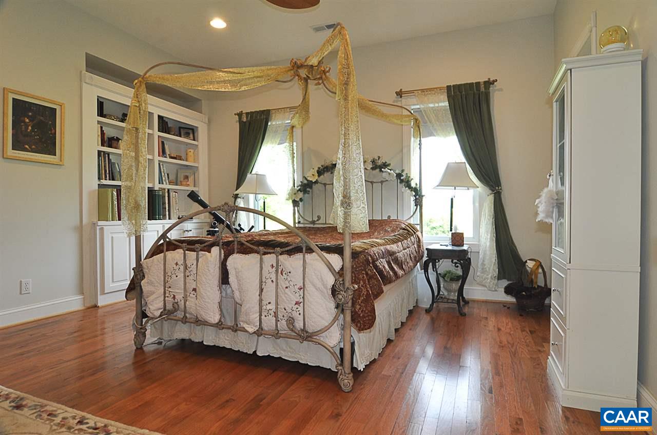 341 Grace Johnson Road Kents Store, VA 23084 - Photo 23 of 32 a spacious bedroom with a bed and wooden floor