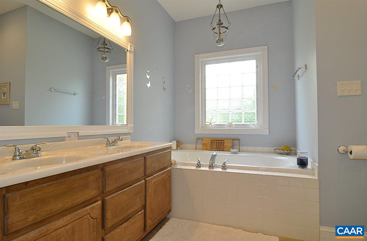 341 Grace Johnson Road Kents Store, VA 23084 - Photo 26 of 32 a bathroom with a tub sink and mirror