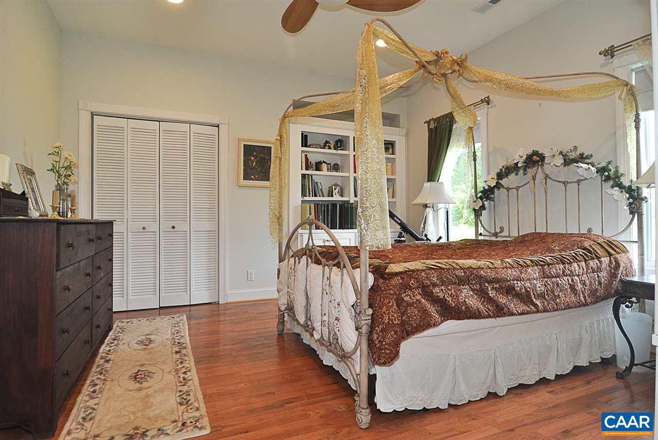 341 Grace Johnson Road Kents Store, VA 23084 - Photo 27 of 32 a bedroom with a bed and wooden floor