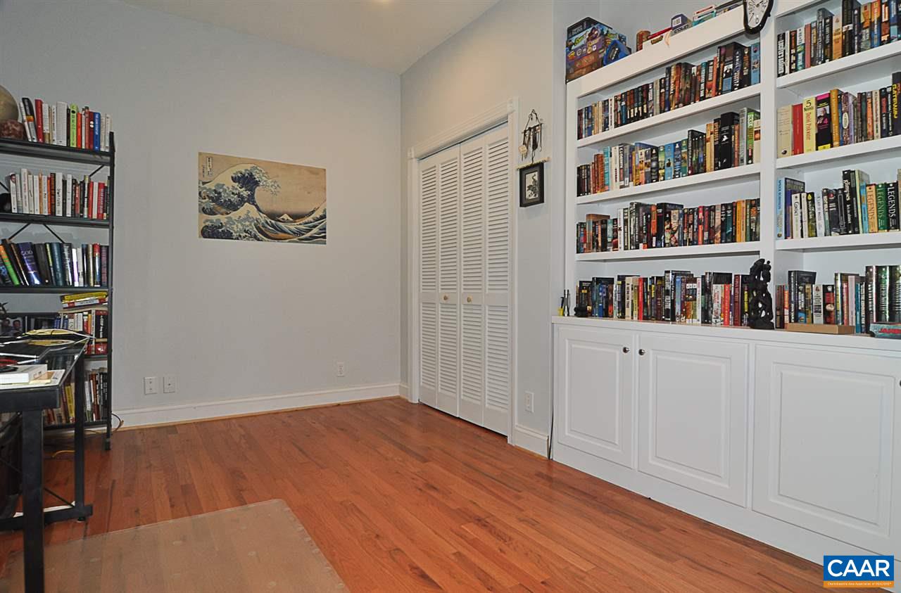 341 Grace Johnson Road Kents Store, VA 23084 - Photo 32 of 32 a view of an empty room with bookshelf and wooden floor