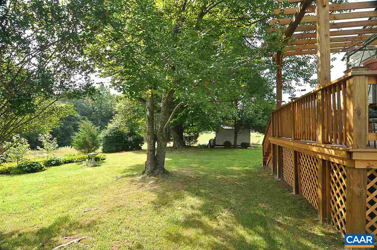 341 Grace Johnson Road Kents Store, VA 23084 - Photo 4 of 32 a view of a backyard with large trees and a small yard
