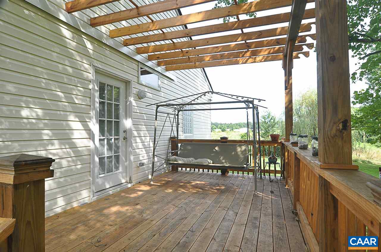 341 Grace Johnson Road Kents Store, VA 23084 - Photo 8 of 32 a view of a balcony with chairs and wooden floor
