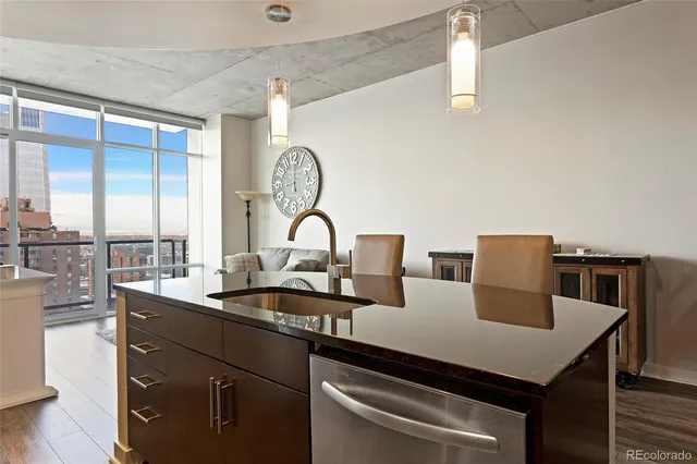 a kitchen with a table chairs and a wooden floor