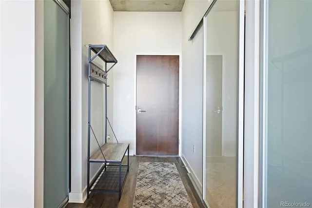 a view of hallway with wooden floor