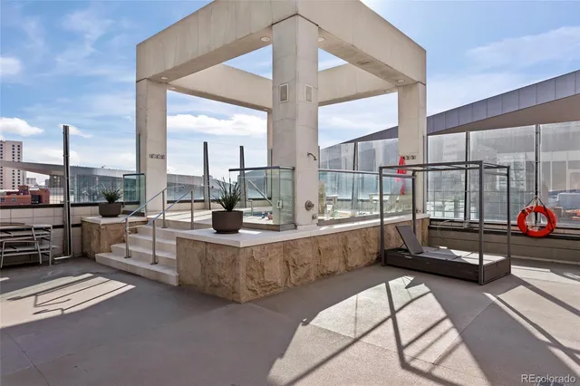 a view of a kitchen with kitchen island granite countertop a large window and a counter space