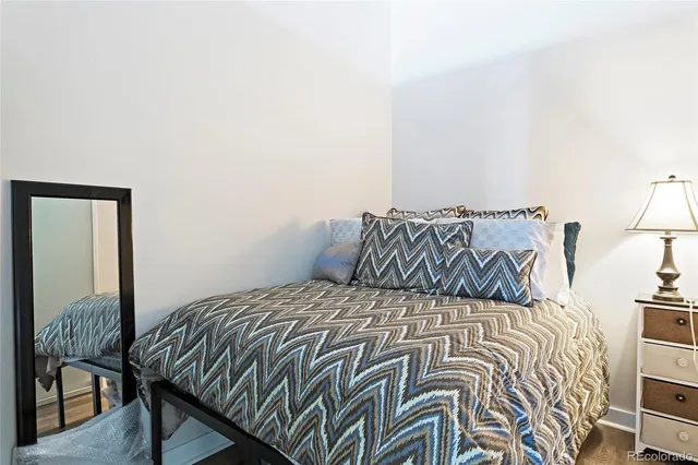 a bed sitting in a bedroom next to a lamp