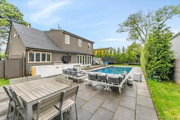 a backyard of a house with table and chairs