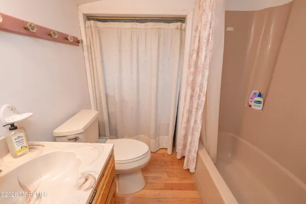 a white toilet sitting next to a bath tub