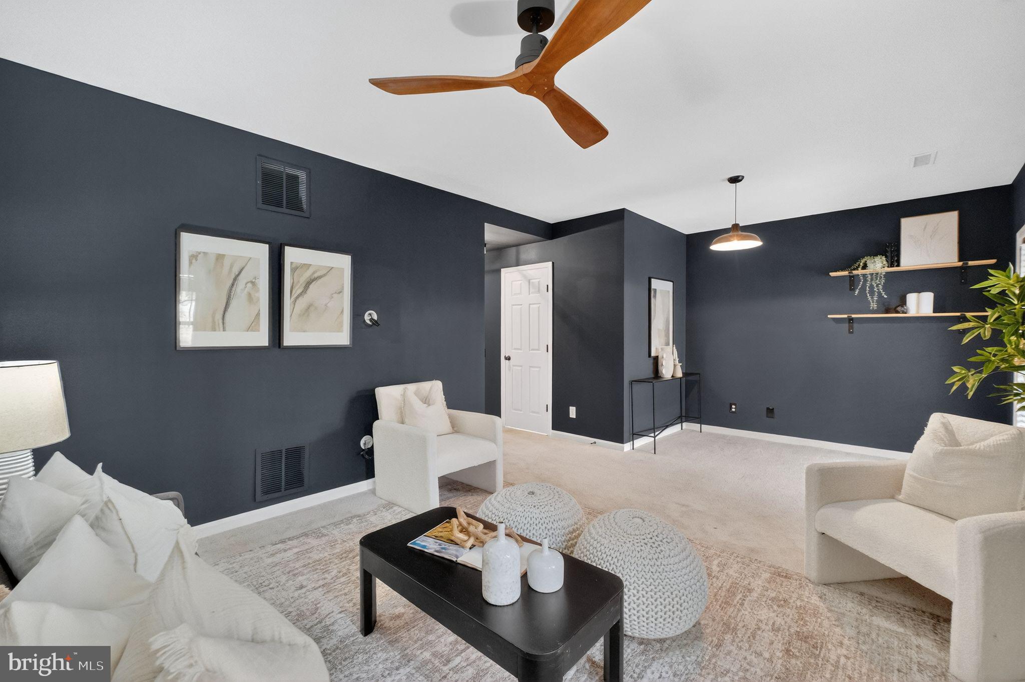 47610 Watkins Island Square Sterling, VA 20165 - Photo 34 of 48 a living room with furniture and a lamp