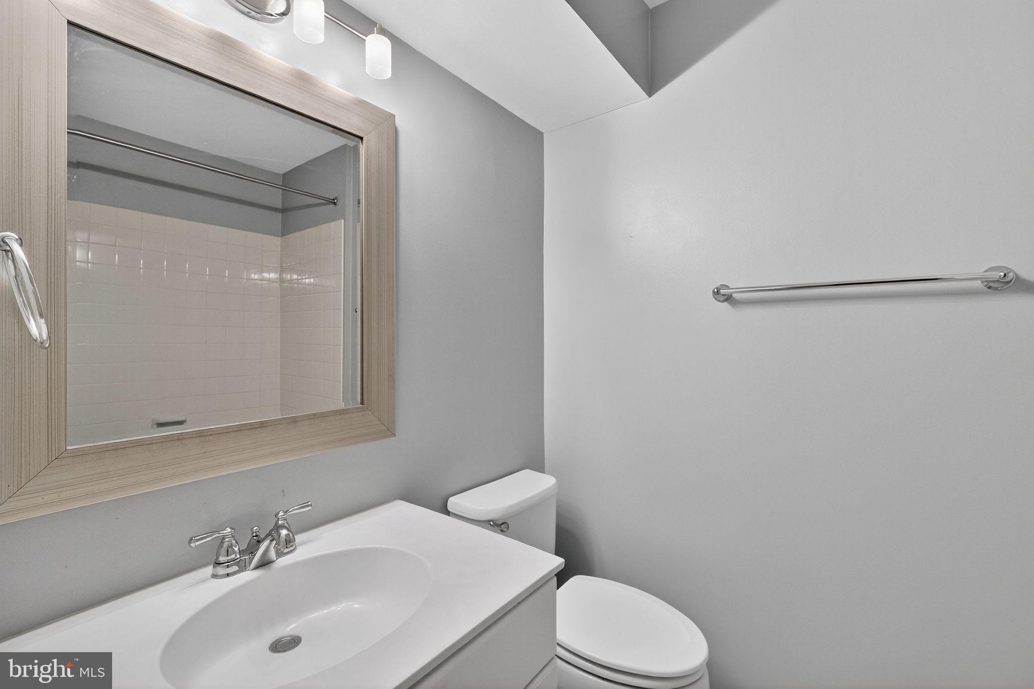 47610 Watkins Island Square Sterling, VA 20165 - Photo 38 of 48 a bathroom with a sink and a toilet