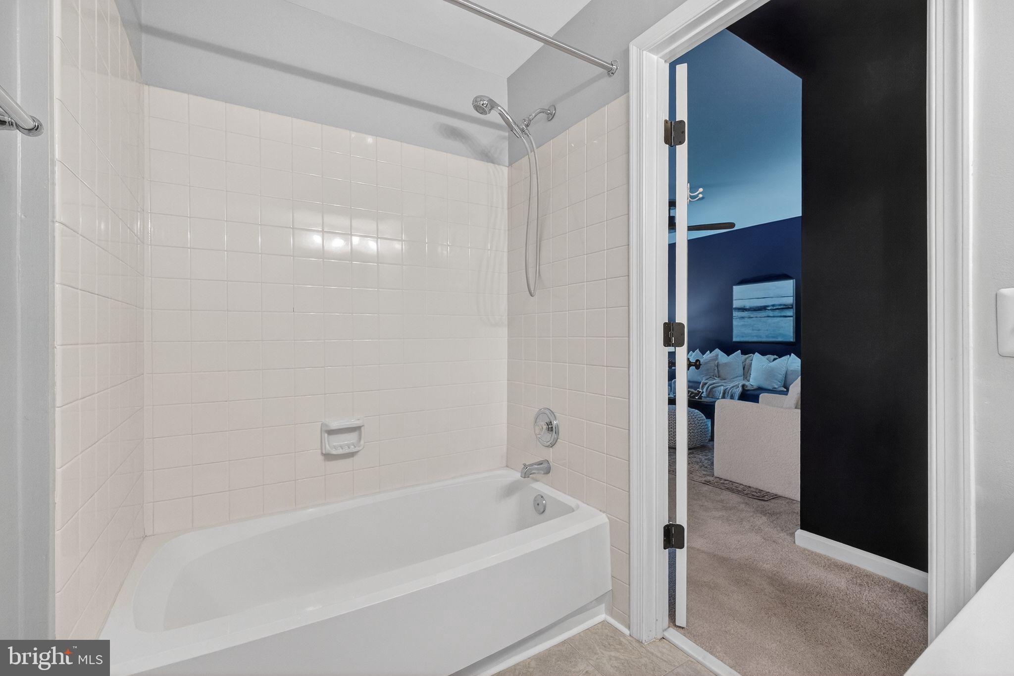 47610 Watkins Island Square Sterling, VA 20165 - Photo 39 of 48 a bathroom with a bathtub and a shower