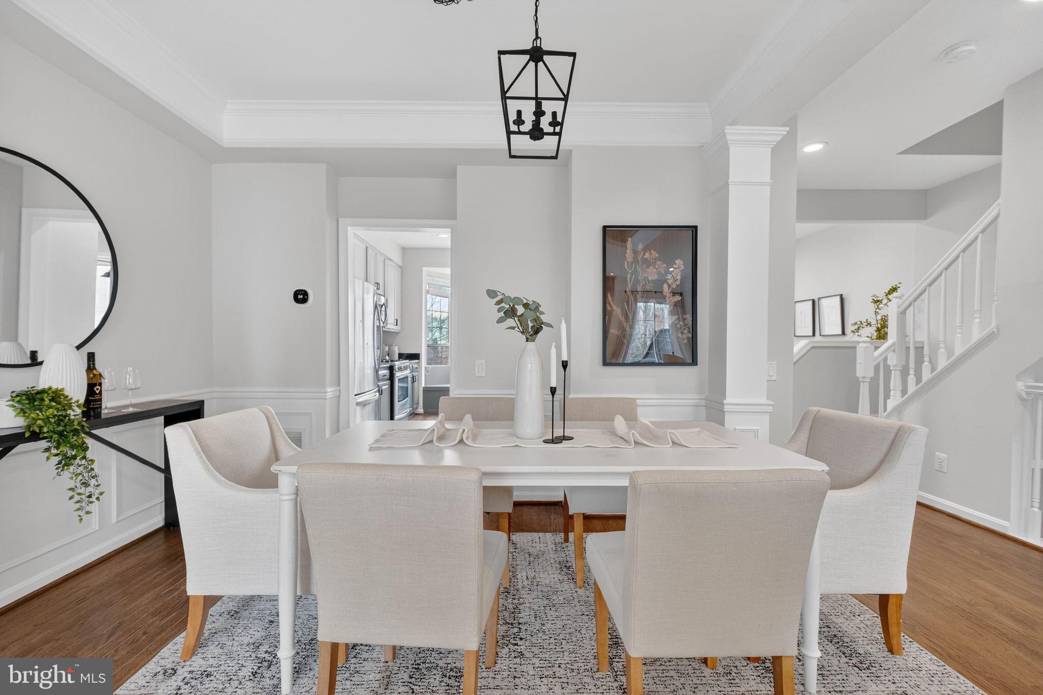 47610 Watkins Island Square Sterling, VA 20165 - Photo 7 of 48 a dining room with wooden floor a chandelier a wooden table and chairs