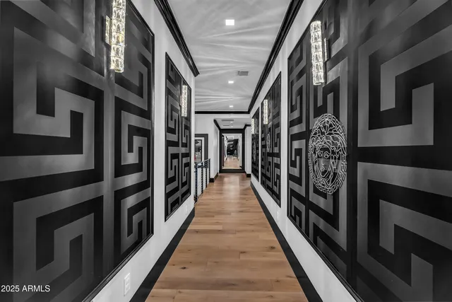 a view of a hallway with wooden floor and staircase