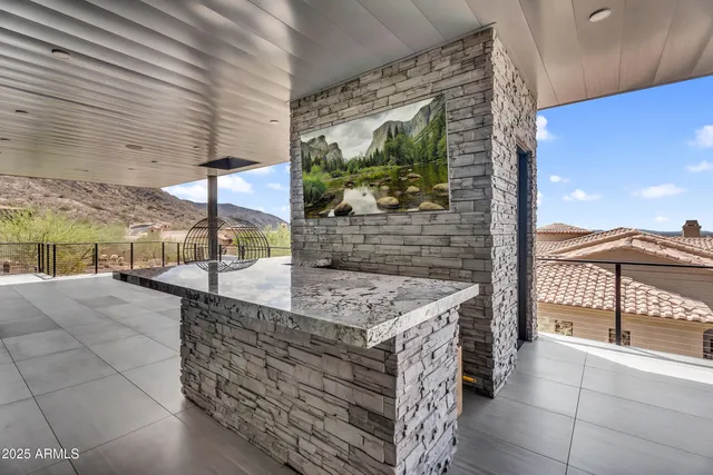 a view of a patio with dining table and chairs with a fire pit