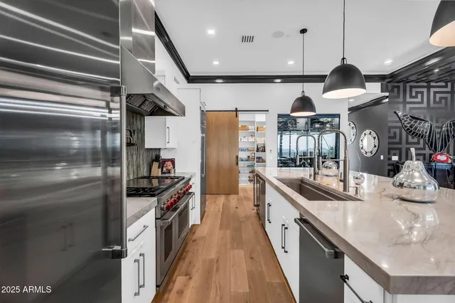 a kitchen with stainless steel appliances granite countertop a stove and a refrigerator