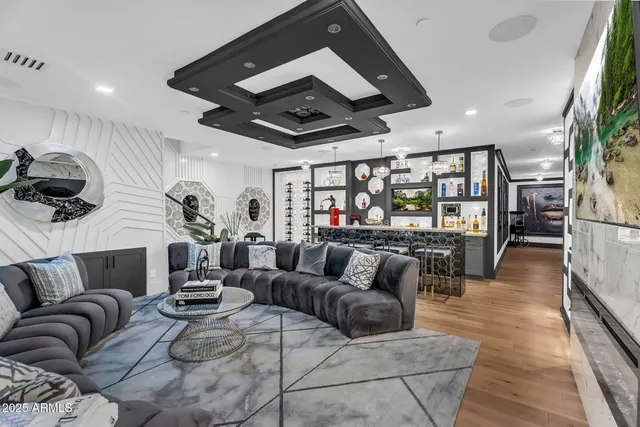 a bedroom with a bed a couch and large window