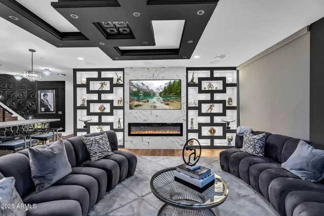 a bedroom with a bed couch and a large window