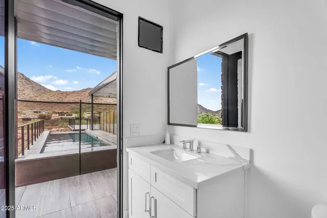 a view of a house with a yard and potted plants