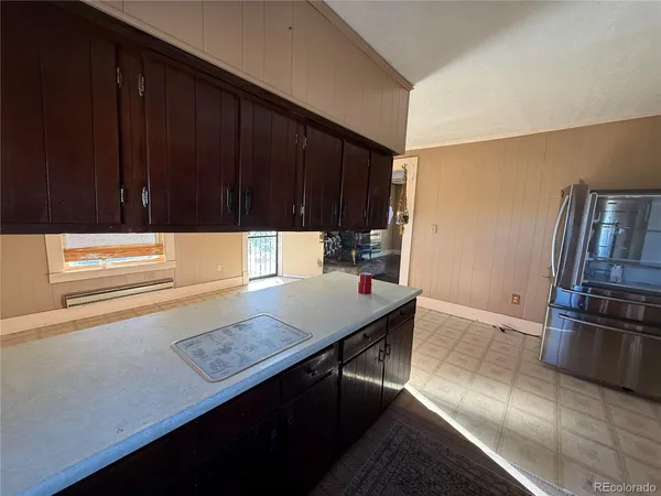 a kitchen with stainless steel appliances a refrigerator and a stove top oven
