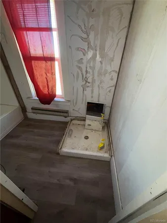 a room with wooden floor and furniture