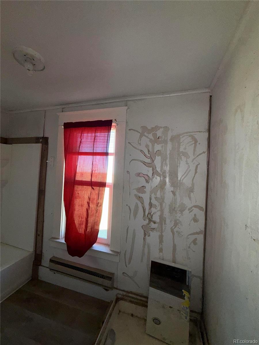 28894 Highway 24 Stratton, CO 80836 - Photo 16 of 41 a room with wooden floor and furniture