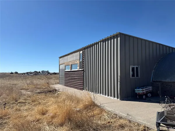 a backyard of a house with lake view and a floor to ceiling window