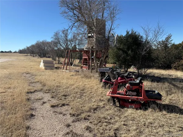 a view of a yard with wooden fence