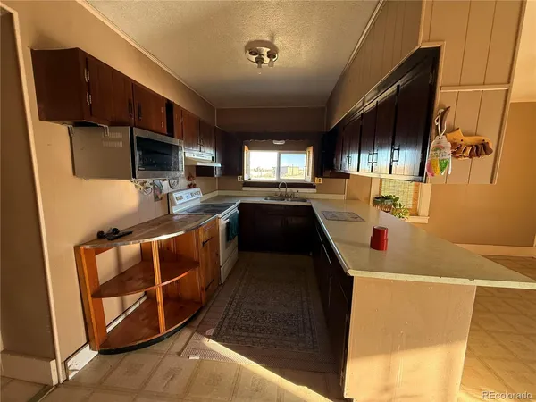 a kitchen that has a sink and a stove in it