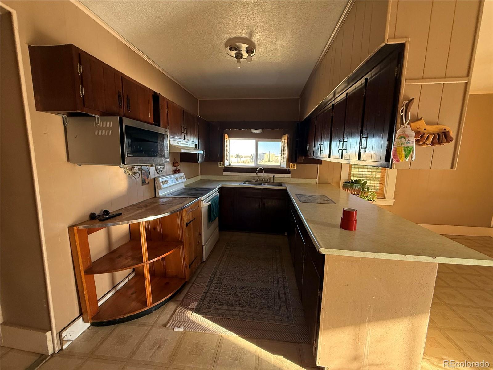 28894 Highway 24 Stratton, CO 80836 - Photo 10 of 41 a kitchen that has a sink and a stove in it