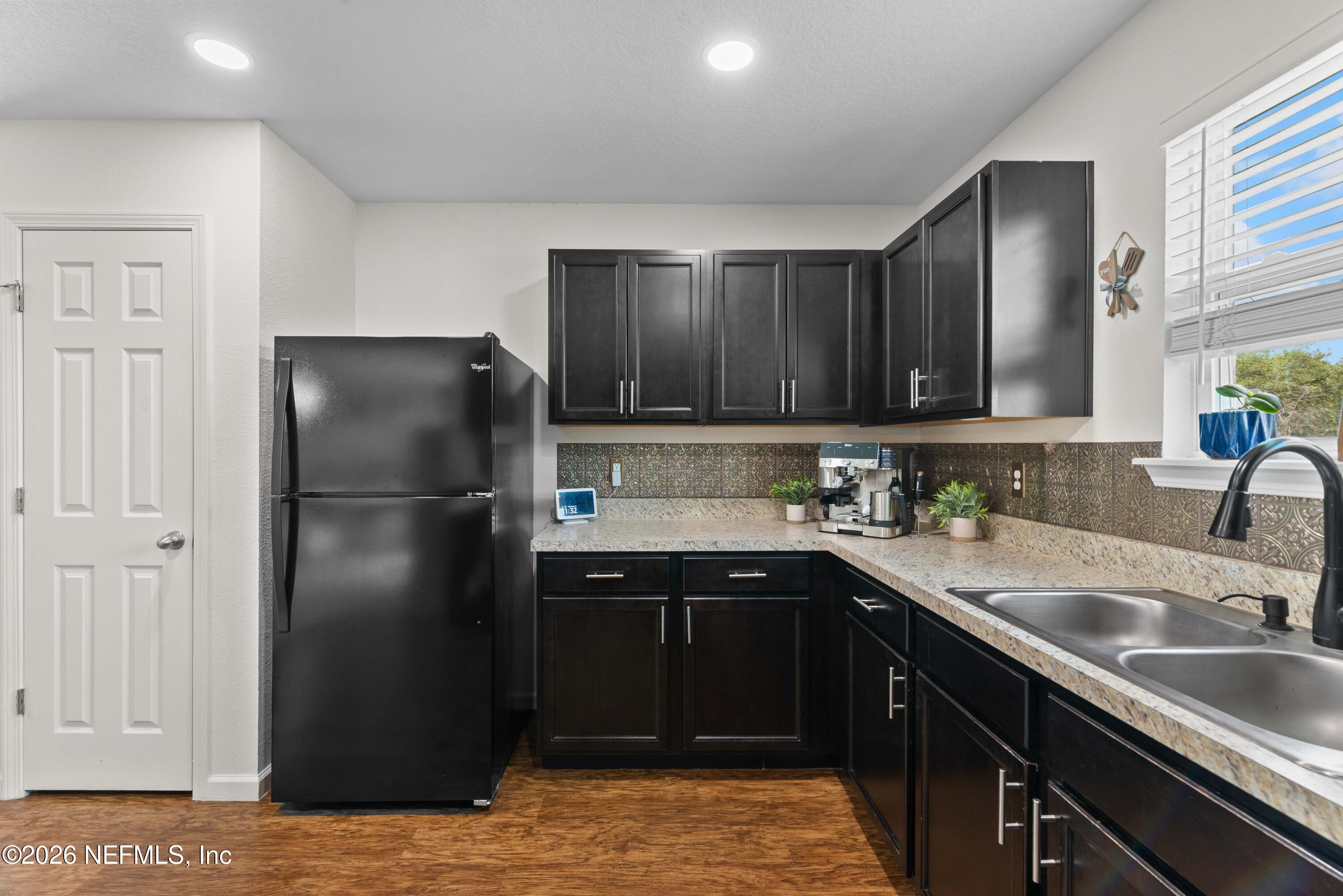 6178 Daylilly Road Macclenny, FL 32063 - Photo 14 of 29 a kitchen with a sink a refrigerator and cabinets