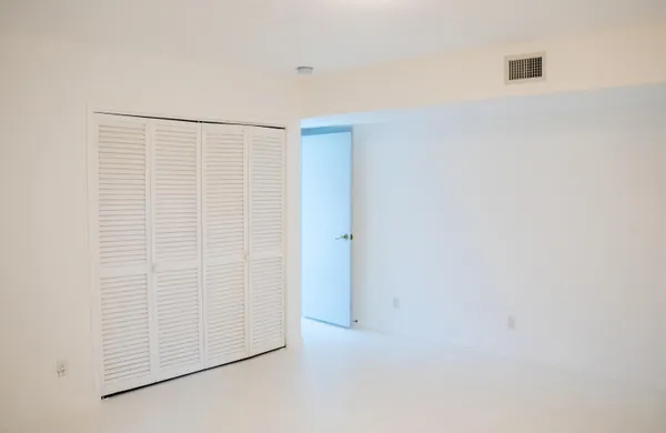 a view of a window with plants and white walls