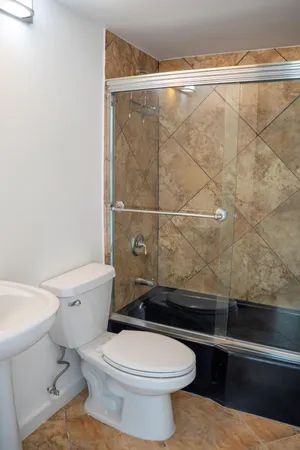 a view of a bathroom with a tub and shower