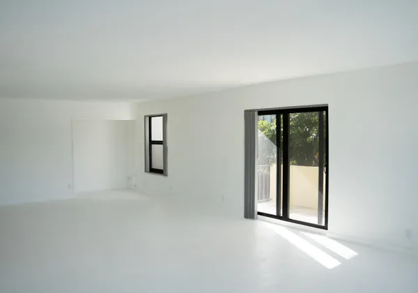 an empty room with windows and closet