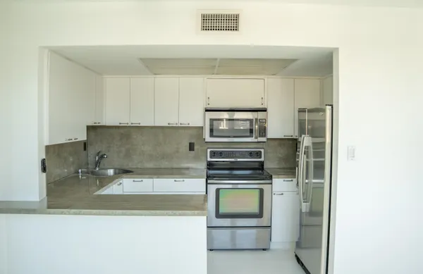 a kitchen with a stove and a refrigerator