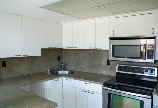 a kitchen with appliances a sink and cabinets