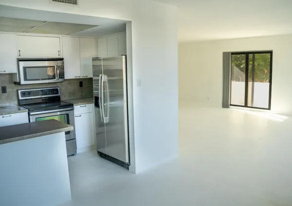 a kitchen with stainless steel appliances a refrigerator and a stove top oven